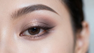 Beginner eyeshadow application on a woman's eye.