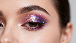 Woman's eye with glitter eyeshadow application.
